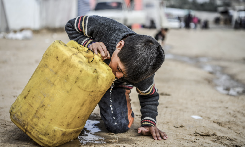 A child drinks from a plastic container in Gaza. More than 2 billion people lack access to safe drinking water. Photograph: Abed Zagout/Anadolu via Getty Images